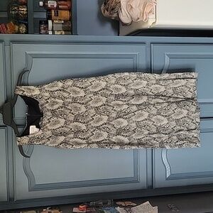 Like new faux snake skin dress. Zip in back. Small slit in back